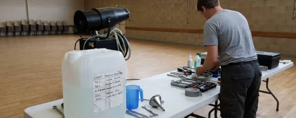 Poste de préparation professionnel avec machine à mousse, bidon de liquide de 20 litres et doseur sur table blanche lumineuse